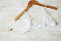 White floral-lace bralette hanging from thin shoulder straps. Photo: Shopify Partners; Shopify Burst white-lingerie-top; Burst Some Rights Reserved. Editorial demo, not manufacturer endorsement.