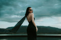 Wind cape-panel dress — editorial photograph 1