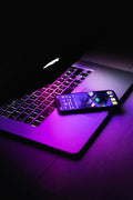 Purple Lit Phone — photograph 1. Photo: AltumCode; https://unsplash.com/photos/a-laptop-with-a-keyboard-KzjqHMlS-uI. Photographic demo.
