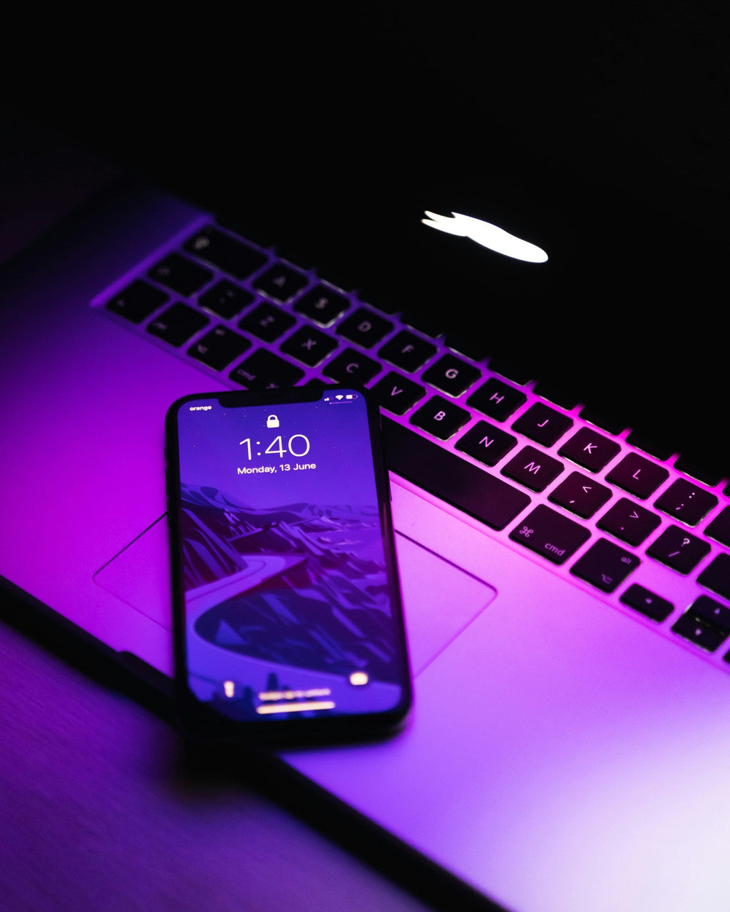 Purple Lit Phone — photograph 3. Photo: AltumCode; https://unsplash.com/photos/a-cell-phone-on-a-laptop-k-Q55_67yxE. Photographic demo.