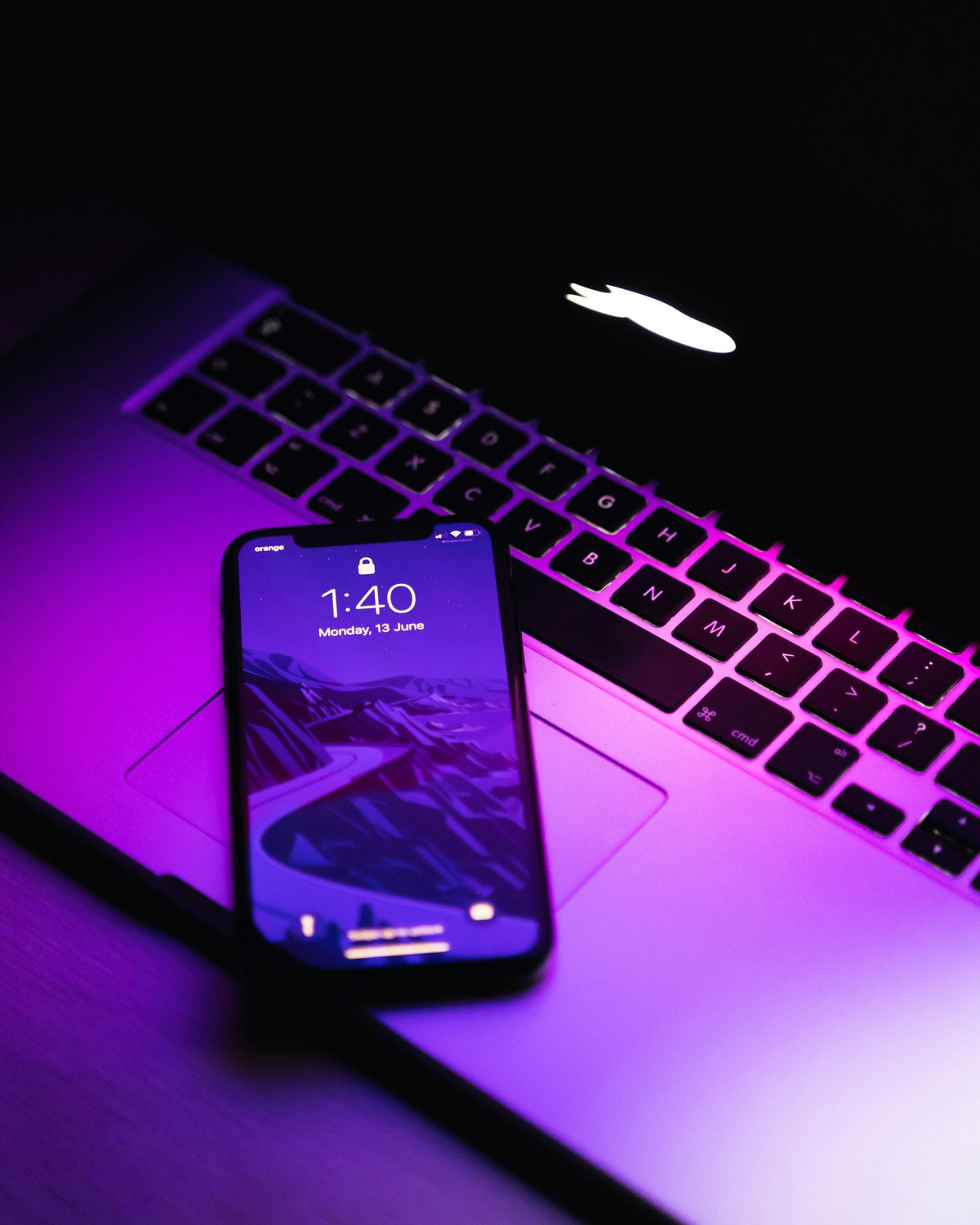 Purple Lit Phone — photograph 3. Photo: AltumCode; https://unsplash.com/photos/a-cell-phone-on-a-laptop-k-Q55_67yxE. Photographic demo.