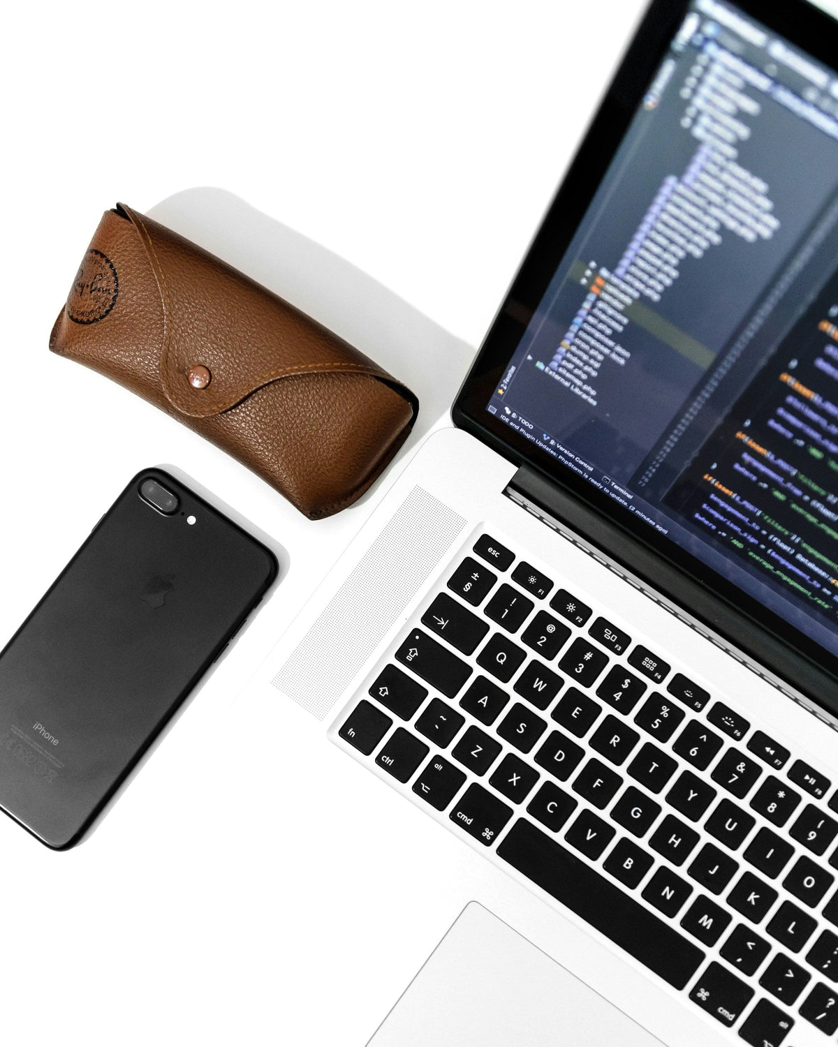 Silver Laptop — photograph 2. Photo: AltumCode; https://unsplash.com/photos/an-open-laptop-computer-sitting-next-to-a-cell-phone-AlPb3jxLbZw. Photographic demo.