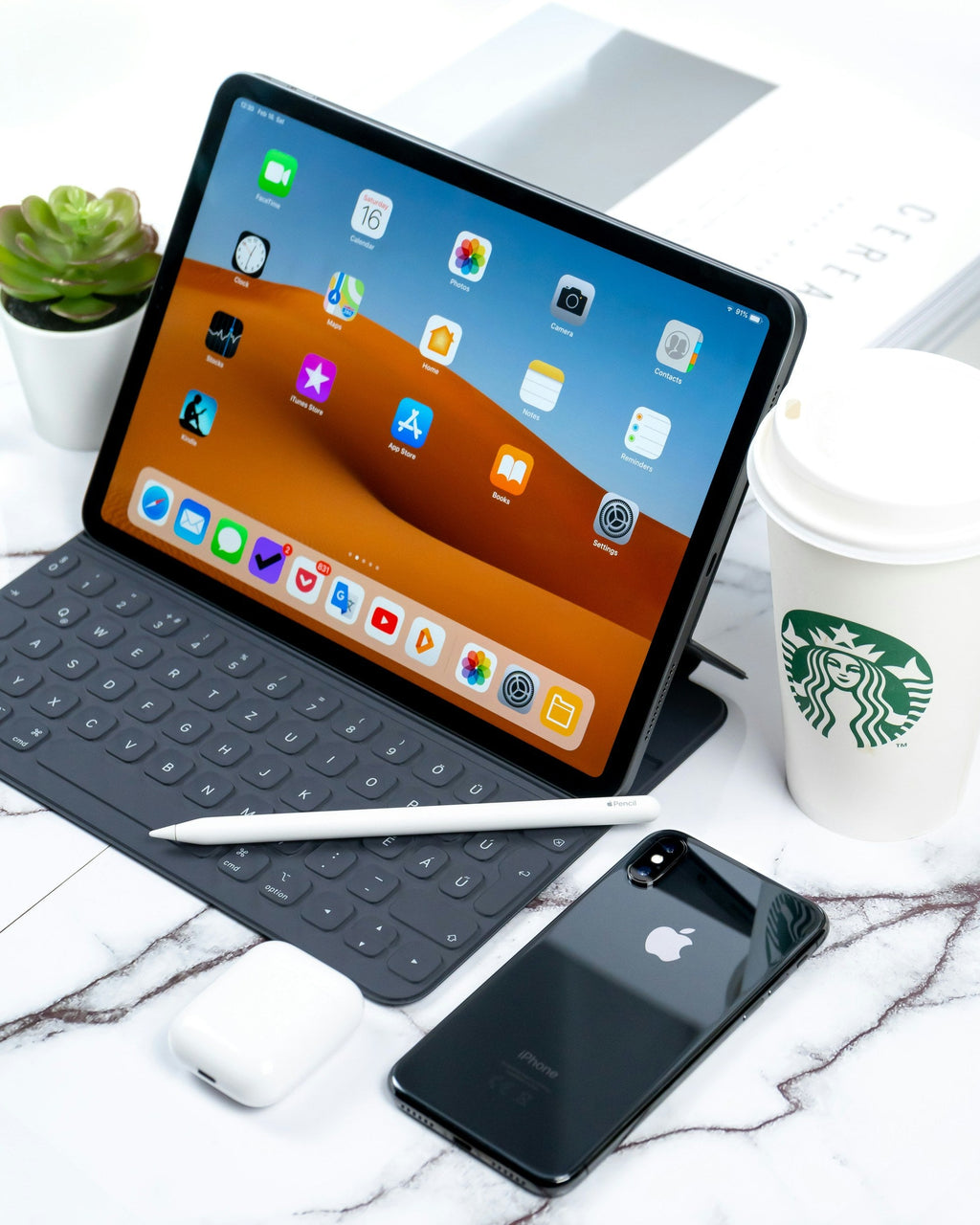 Tablet with Keyboard — Photographic Demo — photograph 2. Photo: Daniel Korpai; https://unsplash.com/photos/turned-on-ipad-beside-space-gray-iphone-x-and-starbucks-coffee-cup-yAu40E-ZyZI. Photographic demo.