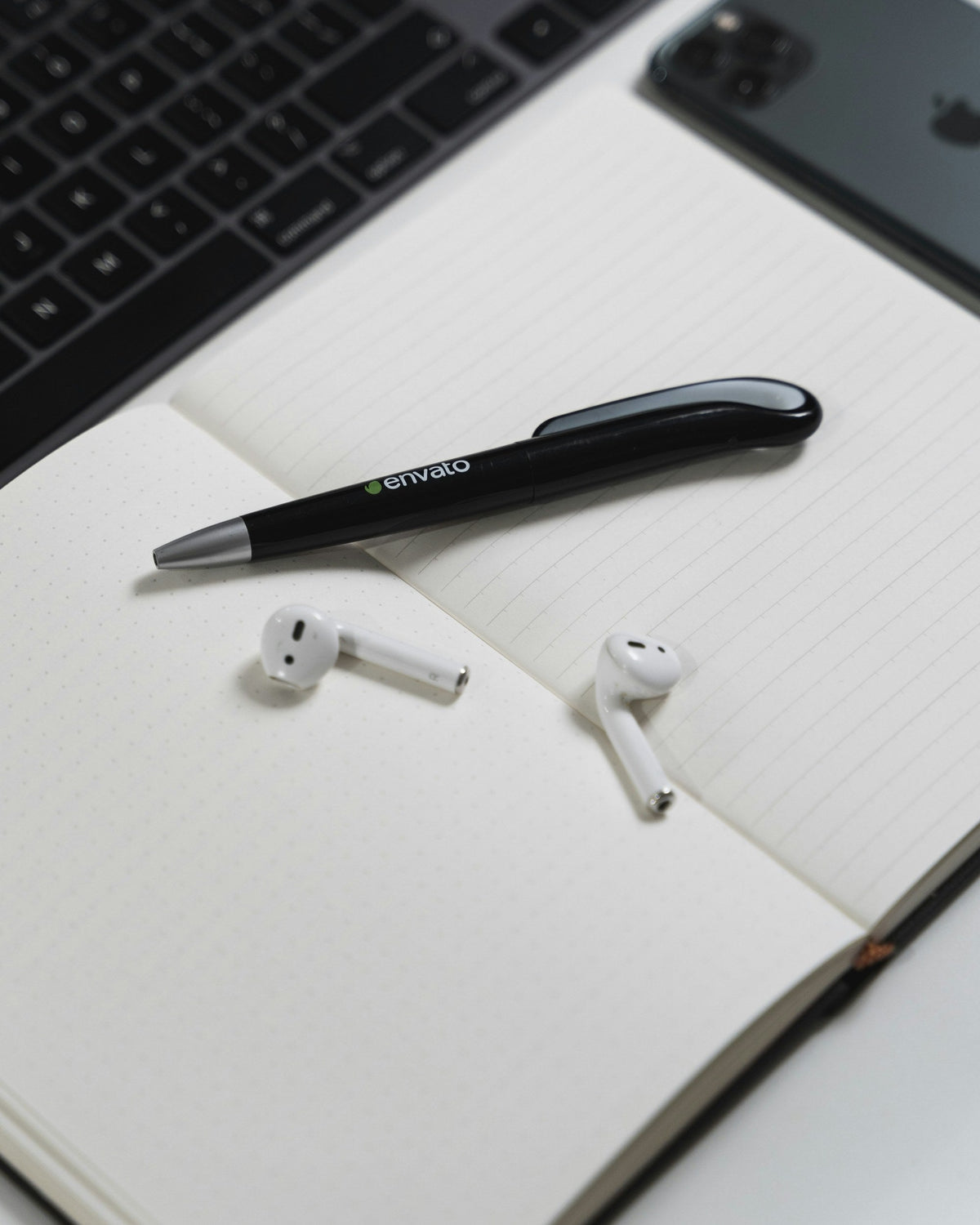 White Stem Earbuds — Photographic Demo — photograph 2. Photo: AltumCode; https://unsplash.com/photos/a-notebook-with-a-pen-and-earbuds-on-top-of-it-MVZypyBygdo. Photographic demo.