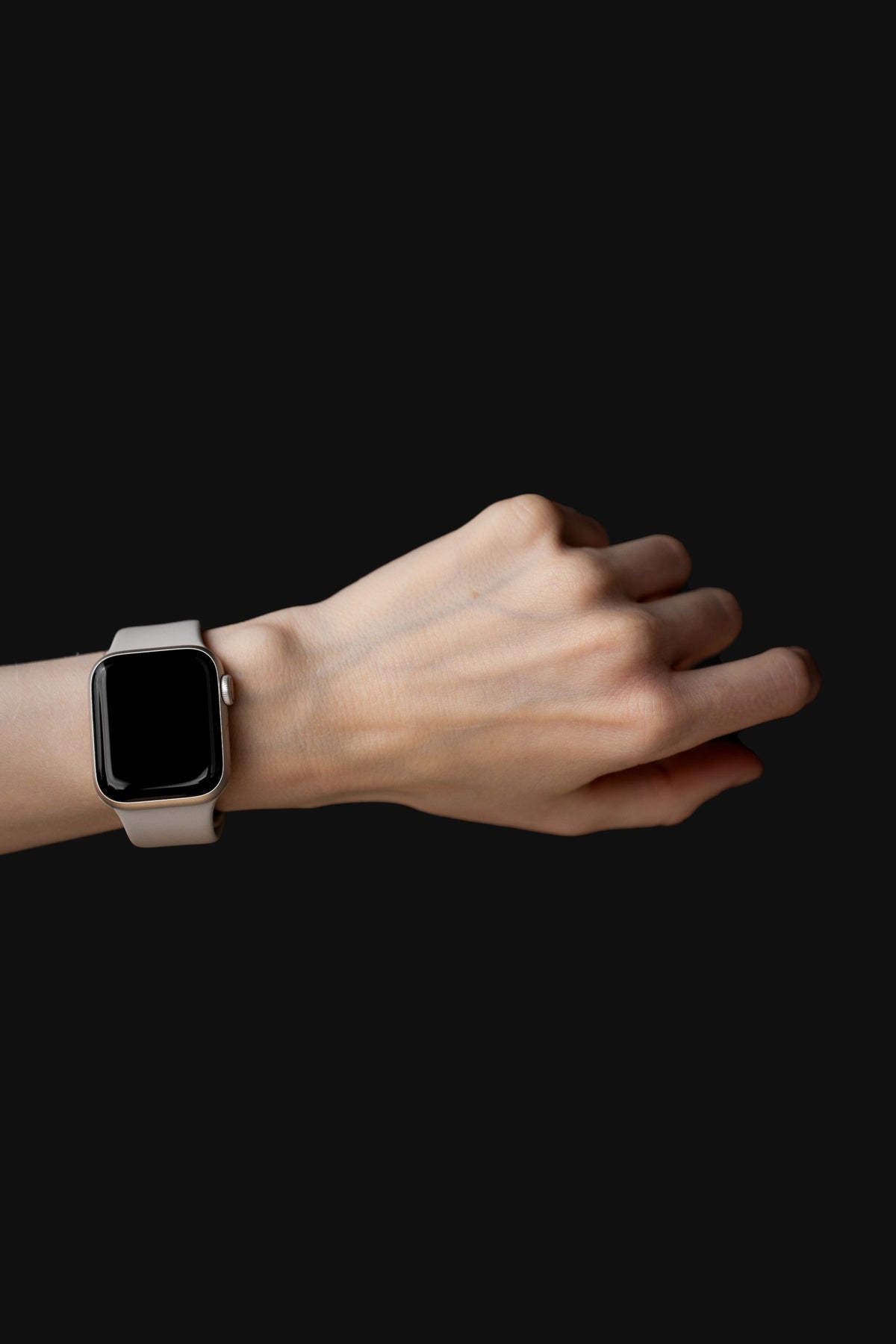 Smartwatch worn on a wrist against a black background