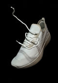 Road Tempo — white knit road running shoe, single-shoe product shot, laces in motion, studio lighting