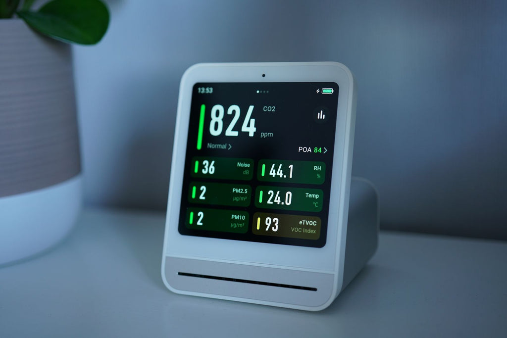 Small white indoor air quality monitor on a table