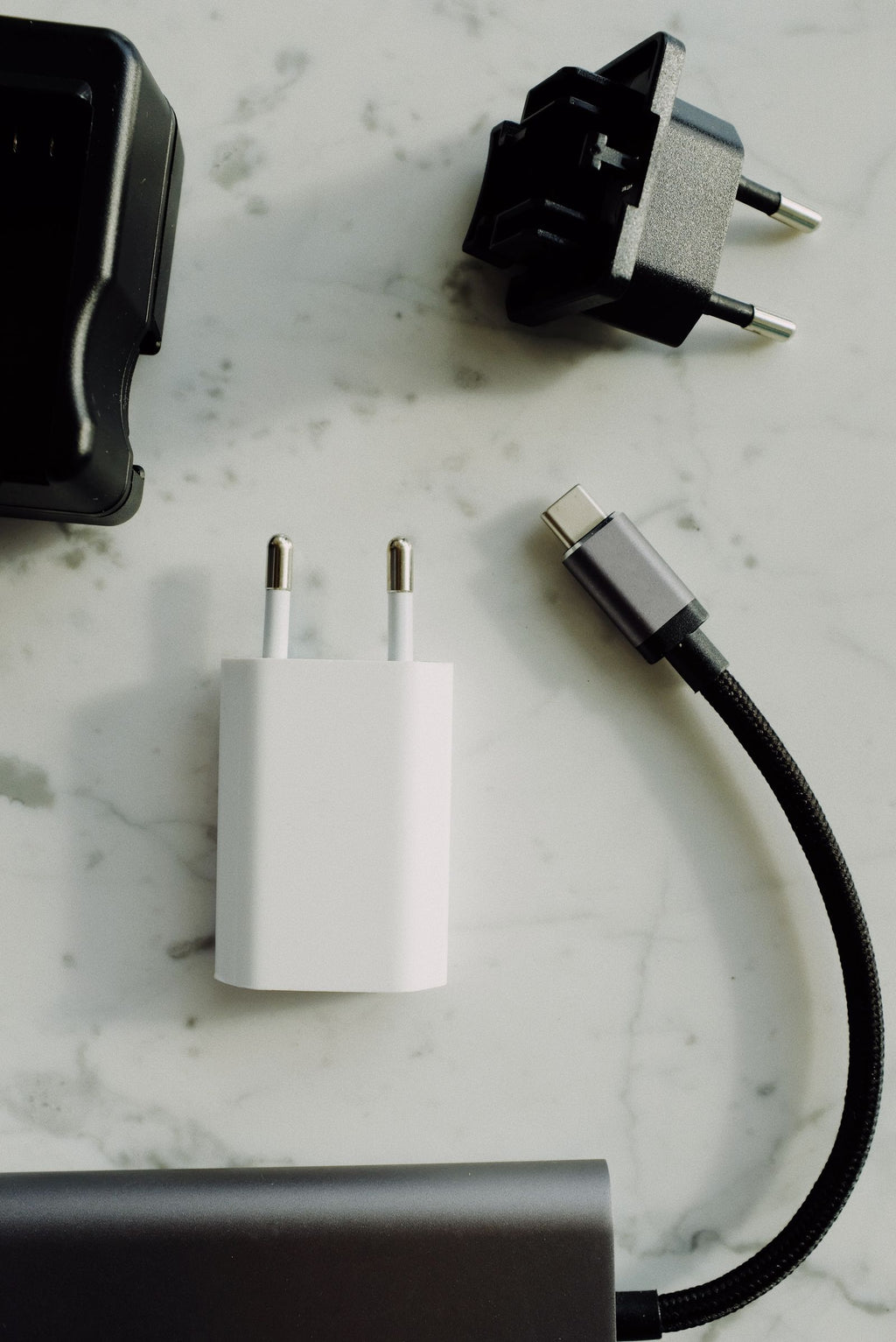 Wall charger beside a braided USB-C cable, overhead view