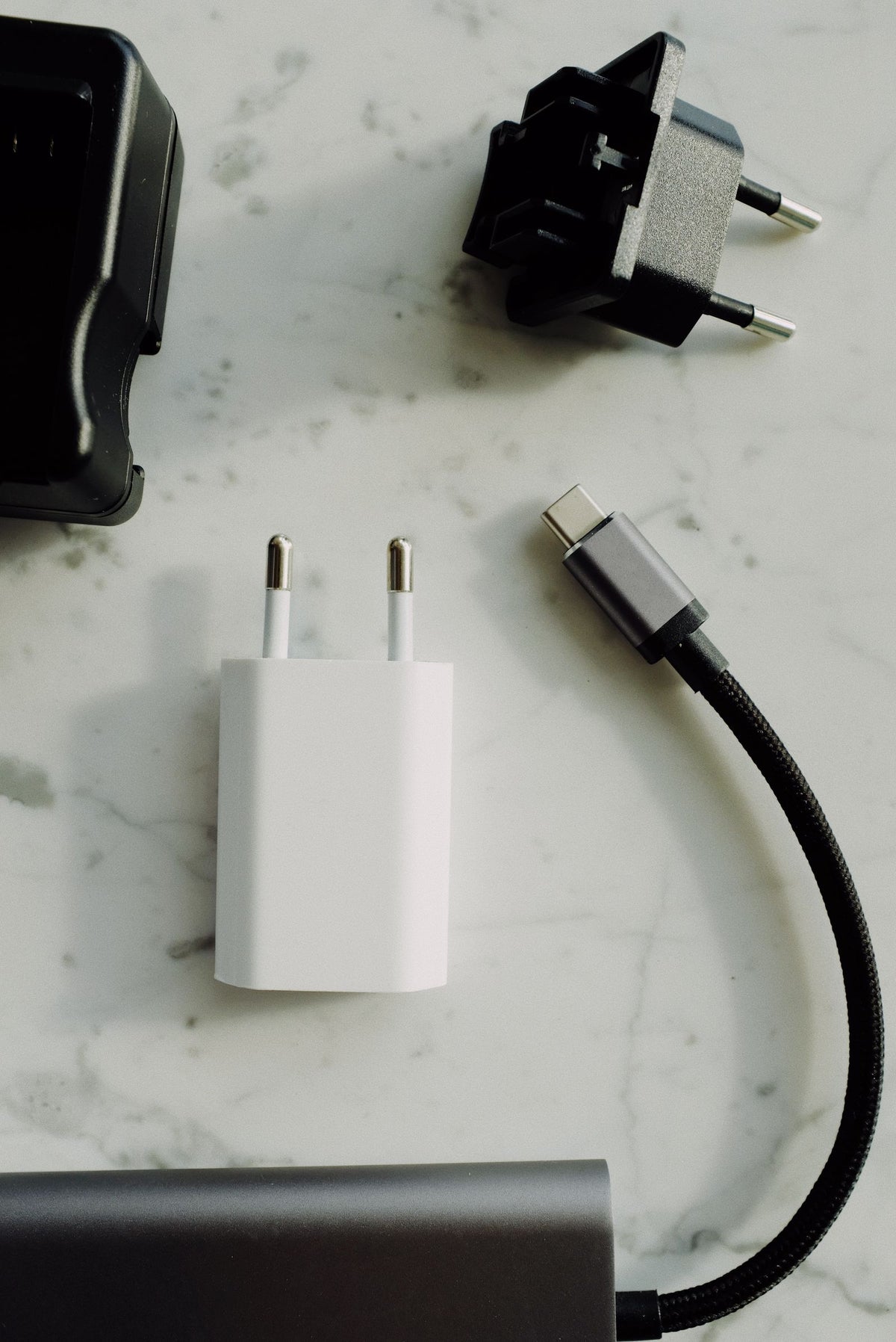 Wall charger beside a braided USB-C cable, overhead view