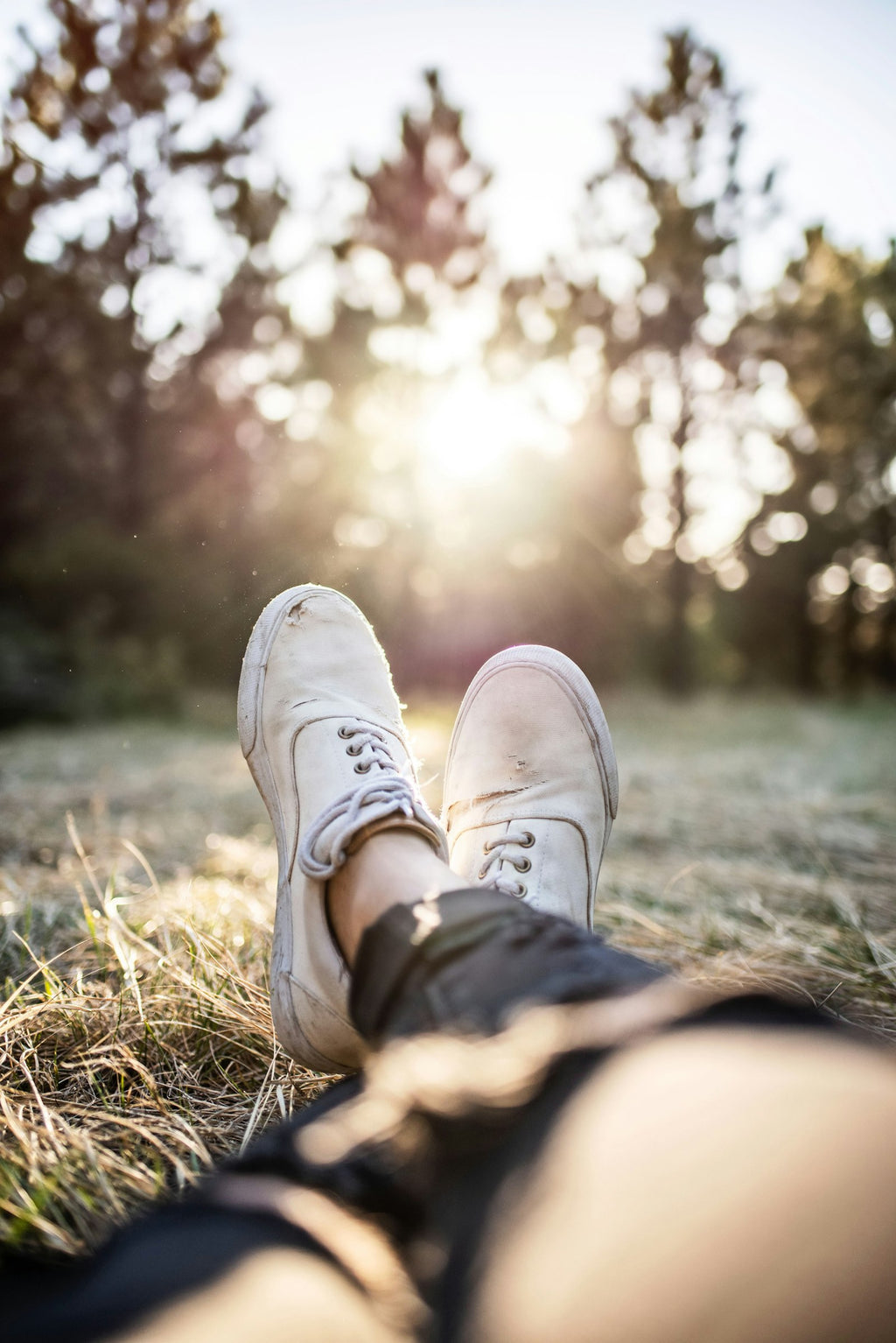 Everyday Knit runners worn outdoors, feet crossed at the ankle in warm evening sunlight