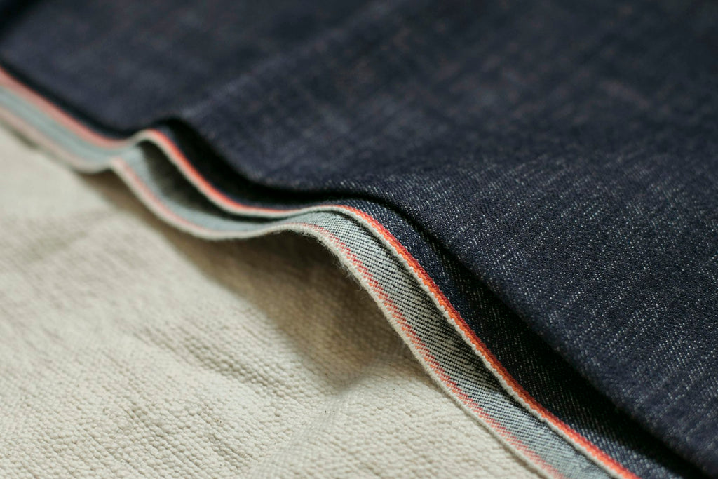 Close-up of a selvedge denim hem with red-line edge
