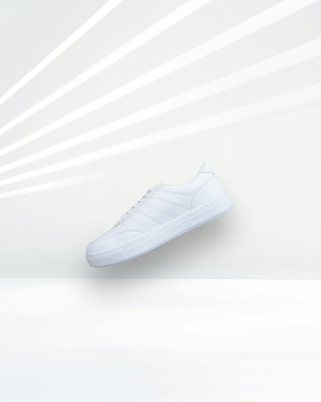 City Court in White — minimal white leather court sneaker floating on a light studio backdrop