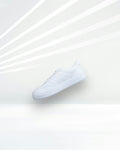 City Court in White — minimal white leather court sneaker floating on a light studio backdrop