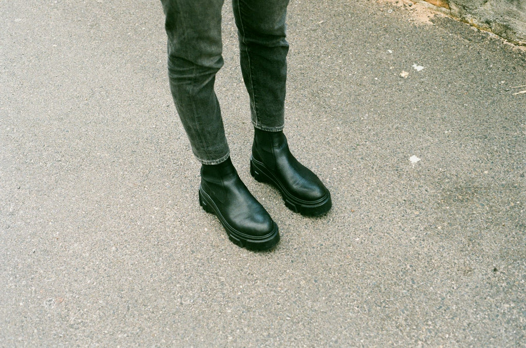 City Chelsea boots worn with dark trousers on grey pavement, showing the elastic gore and lug sole