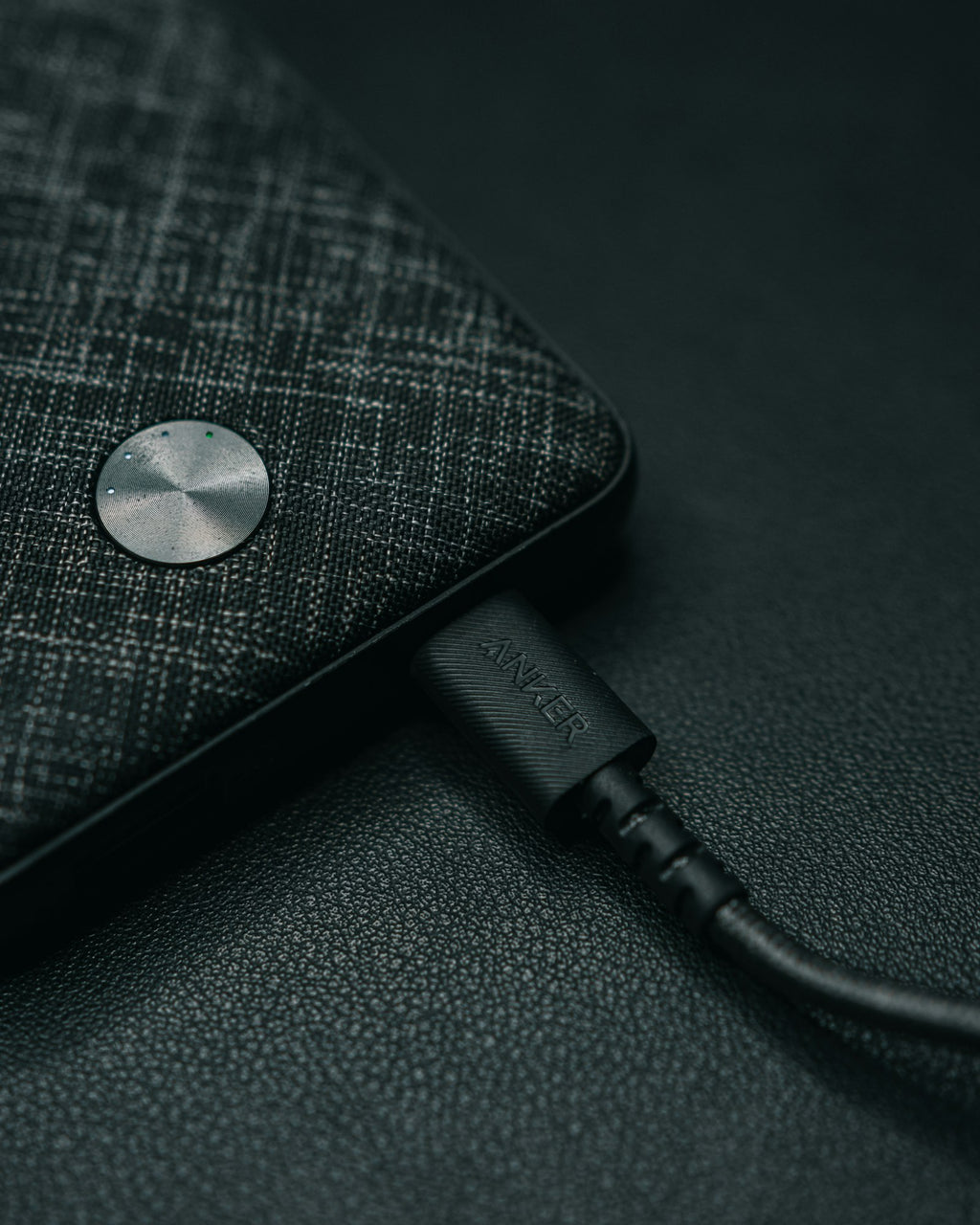 Detail of a USB-C cable plugged into a dark device