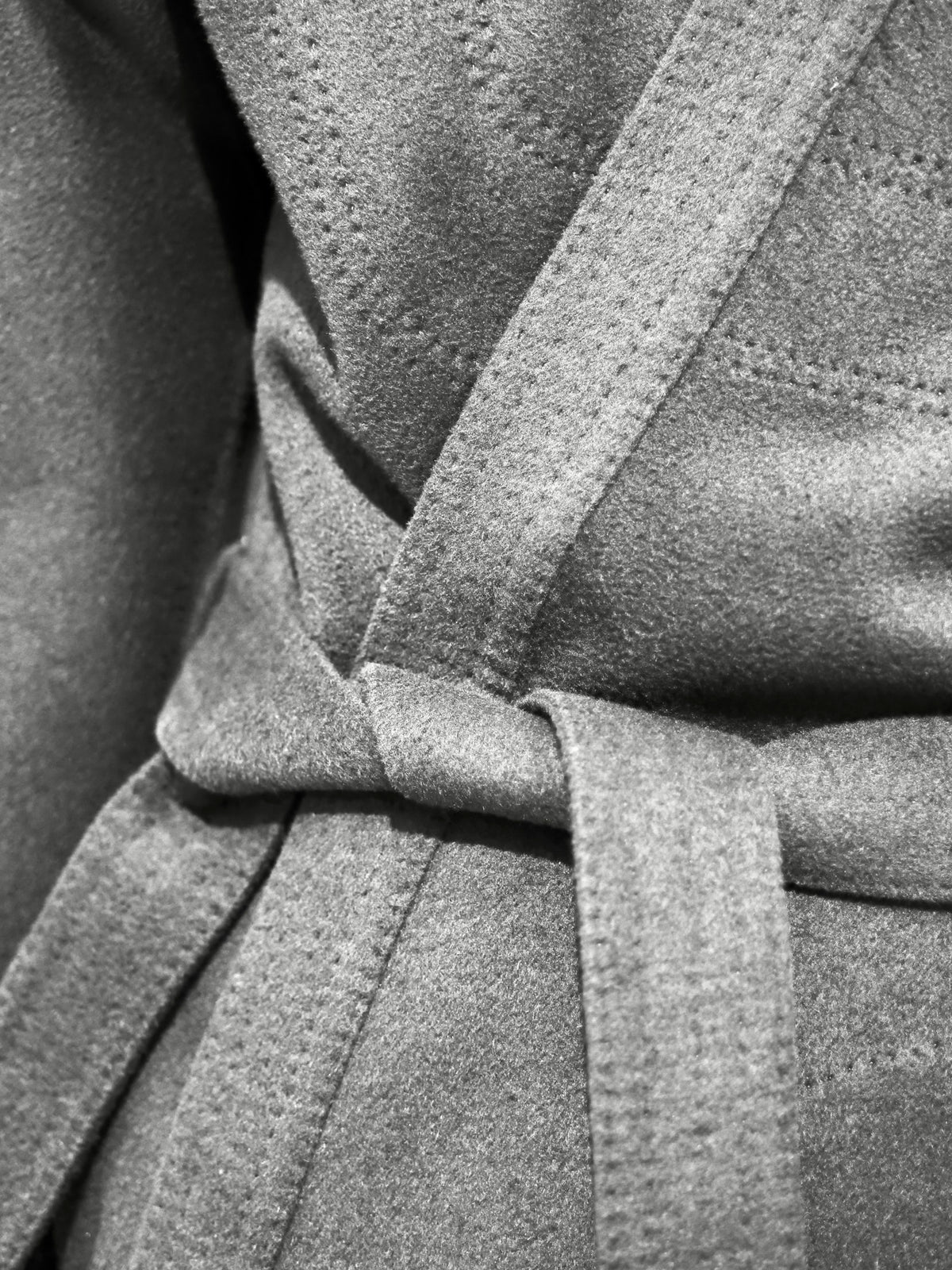 Close-up of the tied belt knot on a wool coat