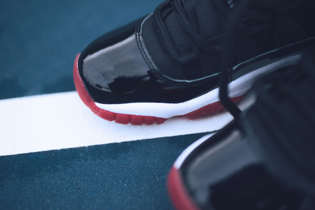 Black Red Patent High Top — Photographic Demo — photograph 2. Photo: Taylor Smith; https://unsplash.com/photos/pair-of-black-and-red-air-jordan-basketball-shoes-bETyrpOyGx0. Photographic demo.