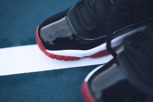Black Red Patent High Top — Photographic Demo — photograph 2. Photo: Taylor Smith; https://unsplash.com/photos/pair-of-black-and-red-air-jordan-basketball-shoes-bETyrpOyGx0. Photographic demo.