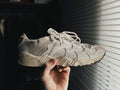 Sand Segmented Runner — Photographic Demo — photograph 1. Photo: @felirbe; https://unsplash.com/photos/a-person-holding-up-a-white-sneaker-in-front-of-a-window-Hl0gJVOqgUE. Photographic demo.