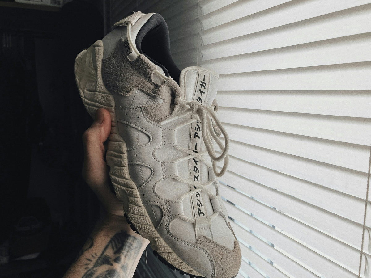 Sand Segmented Runner — Photographic Demo — photograph 2. Photo: @felirbe; https://unsplash.com/photos/a-person-holding-up-a-pair-of-sneakers-vy5j9vJG79k. Photographic demo.