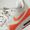 White Orange Air Cushion — Photographic Demo — photograph 1. Photo: Luis Felipe Lins; https://unsplash.com/photos/white-red-and-black-nike-air-max-8T-LD_wxlSo. Photographic demo.