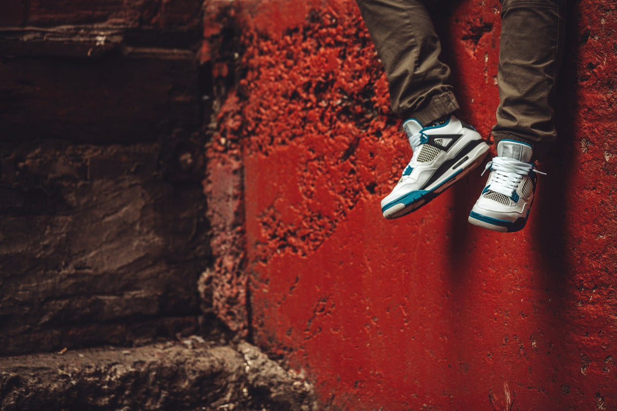 White Teal Sneaker — Photographic Demo — photograph 3. Photo: Matthew Henry; https://www.shopify.com/stock-photos/photos/trainers-in-front-of-red-wall. Photographic demo.